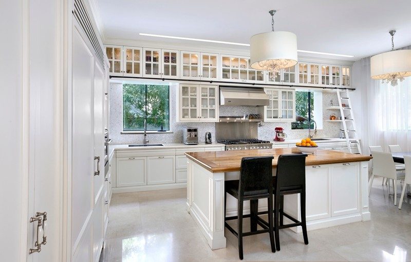 Palm Beach estate white shaker kitchen with butcher block and library ladder by iKitchen Cabinetry