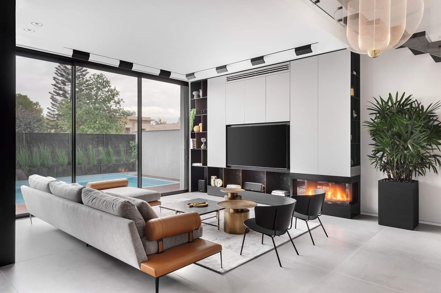 Media wall with a linear fire and full-height glazing — custom media wall by iKitchen Cabinetry