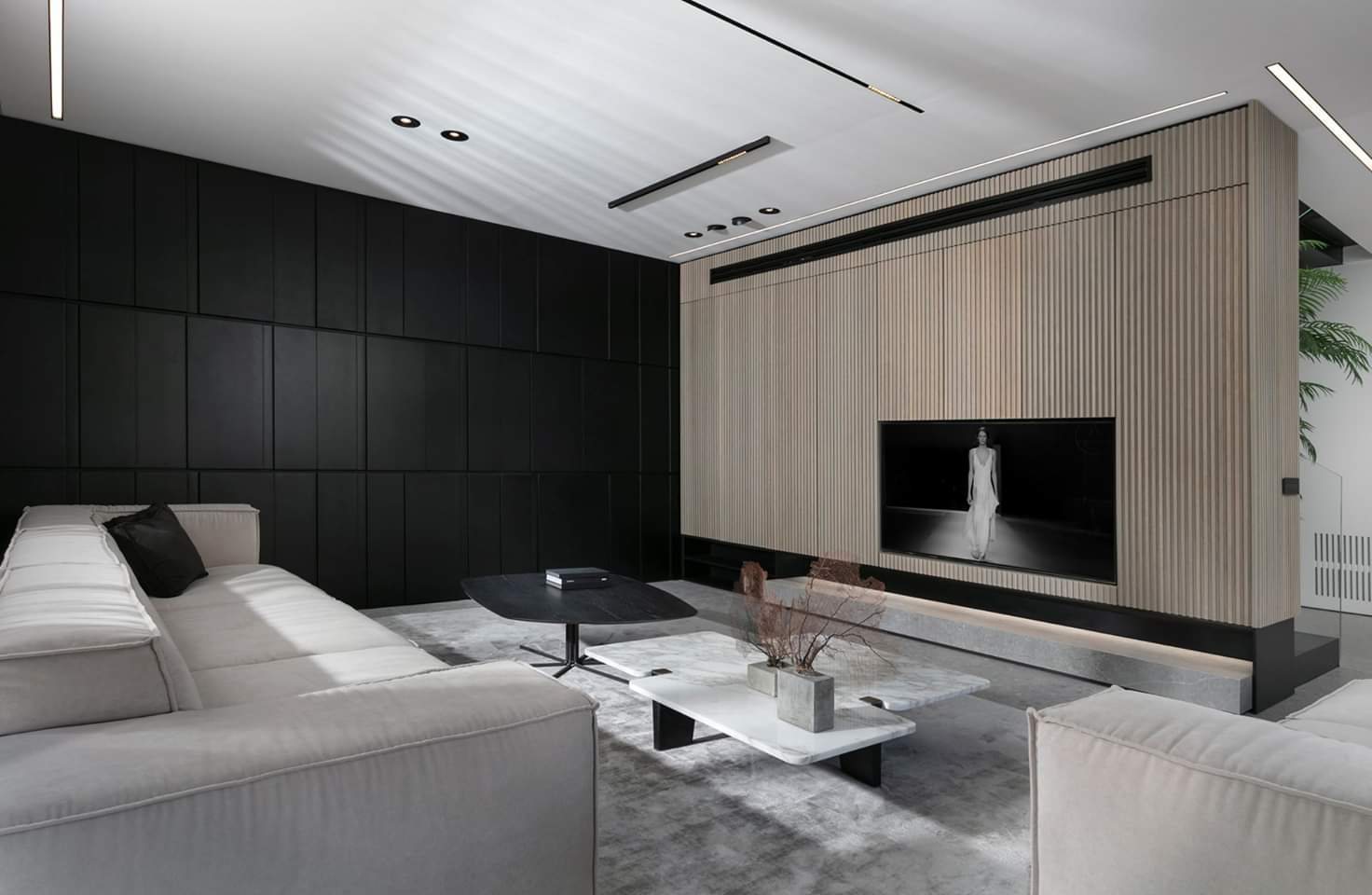 Dark panelled wall wrapping the corner into timber — custom media wall by iKitchen Cabinetry