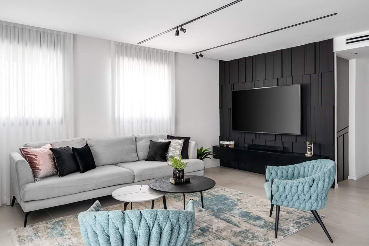 Vertical fluting behind a floating console — custom media wall by iKitchen Cabinetry
