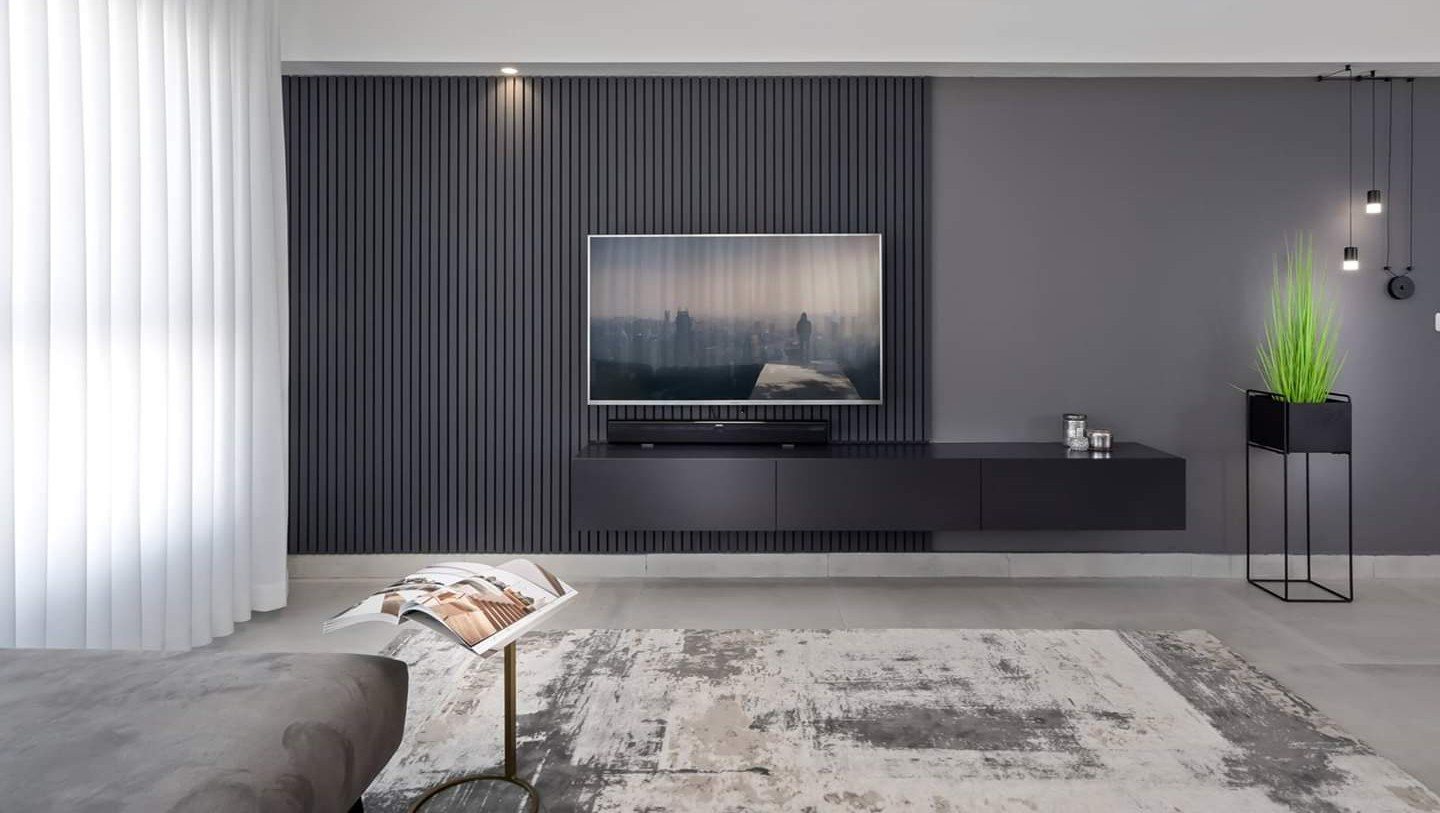 Charcoal fluting with a suspended shelf — custom media wall by iKitchen Cabinetry