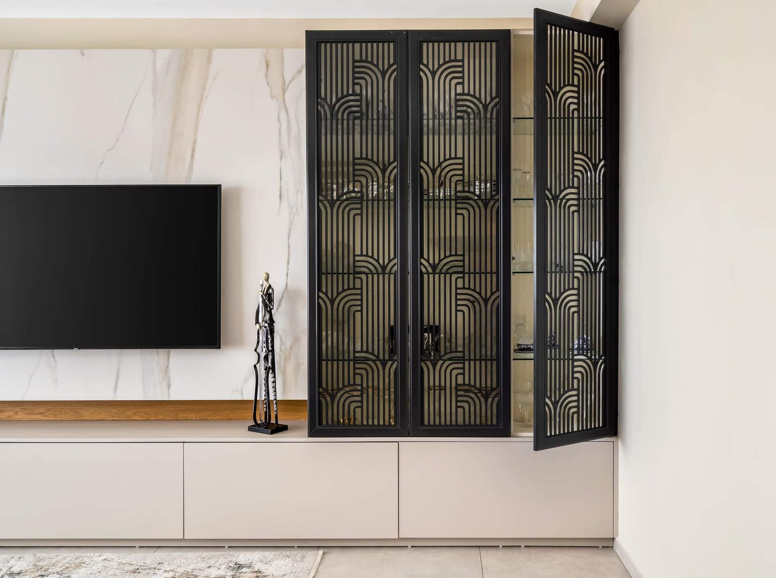 Marble wall with fretwork cabinet doors — custom media wall by iKitchen Cabinetry