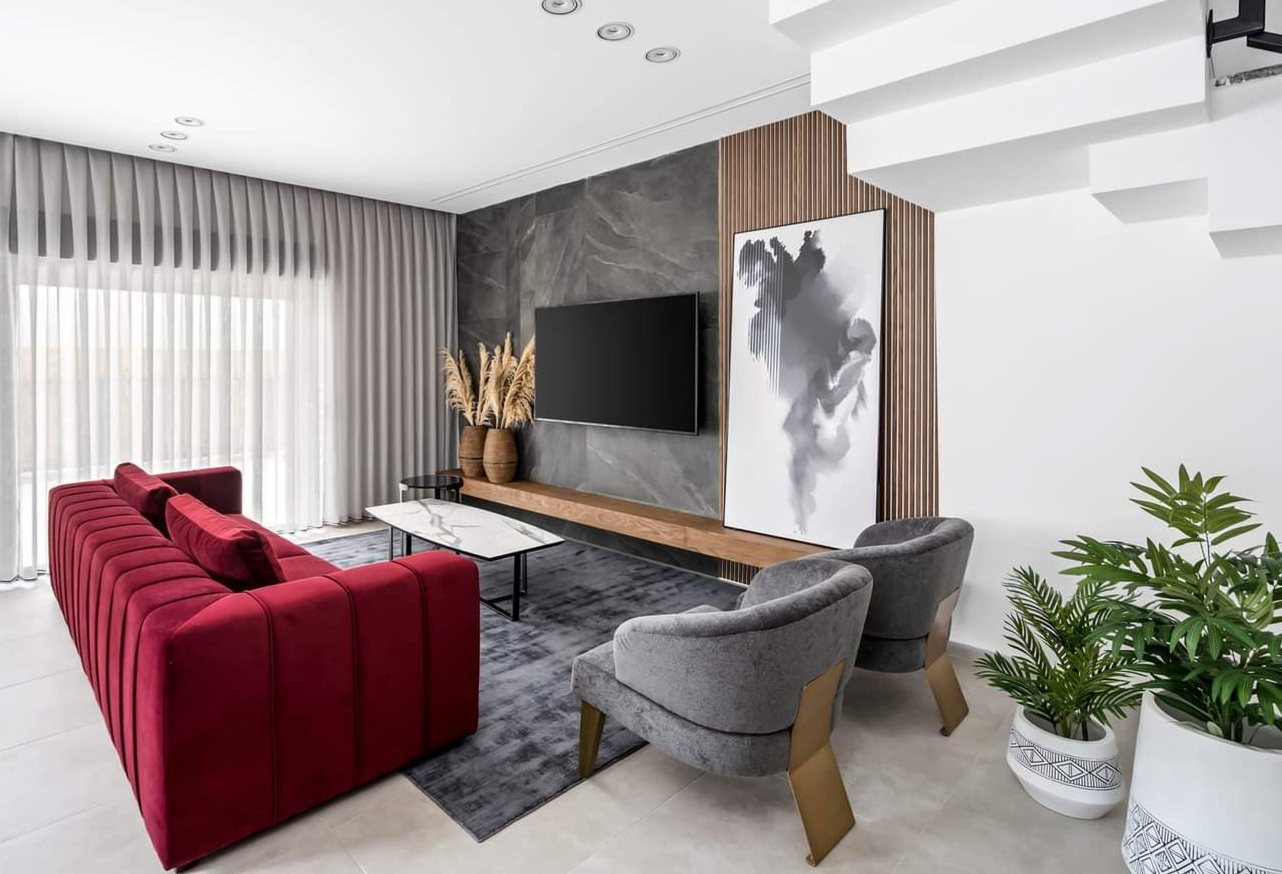 Stone wall, timber shelf and concealed storage — custom media wall by iKitchen Cabinetry