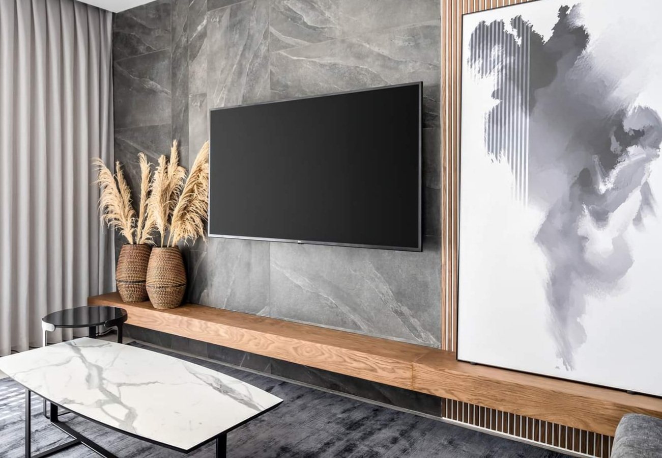 Marble and timber, screen recessed flush — custom media wall by iKitchen Cabinetry