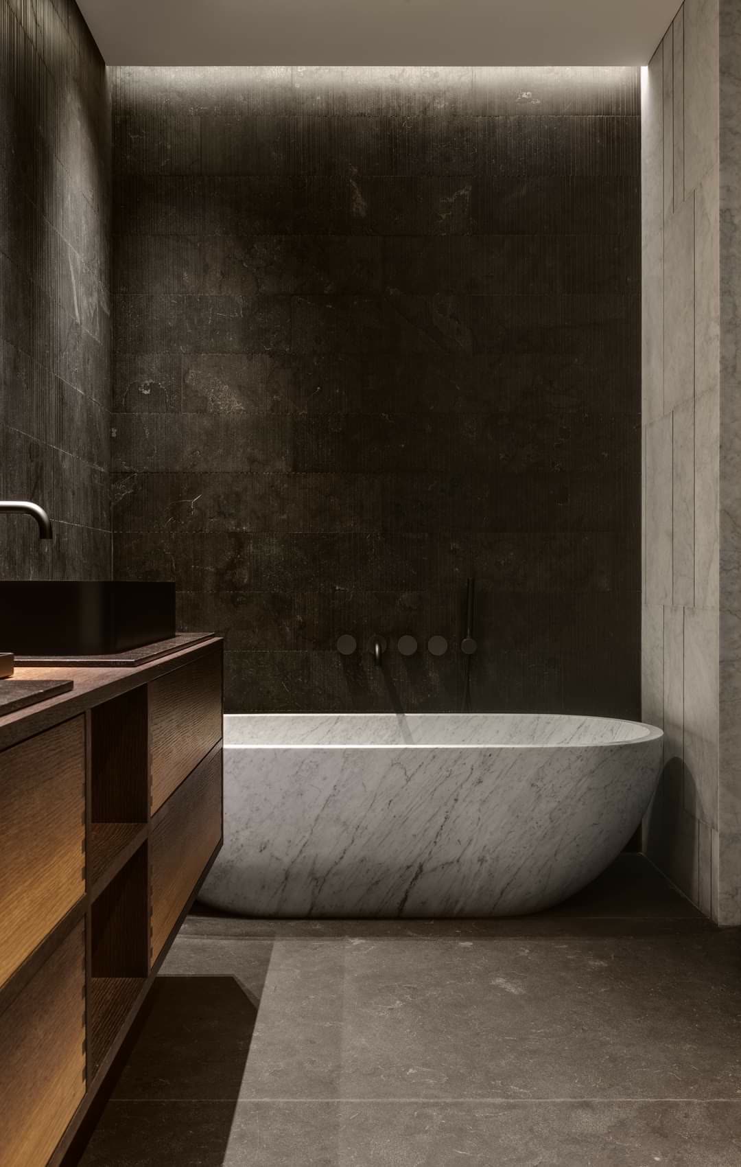 Wide double vanity with two undermount sinks, central drawer bank, and stone countertop in a primary bathroom